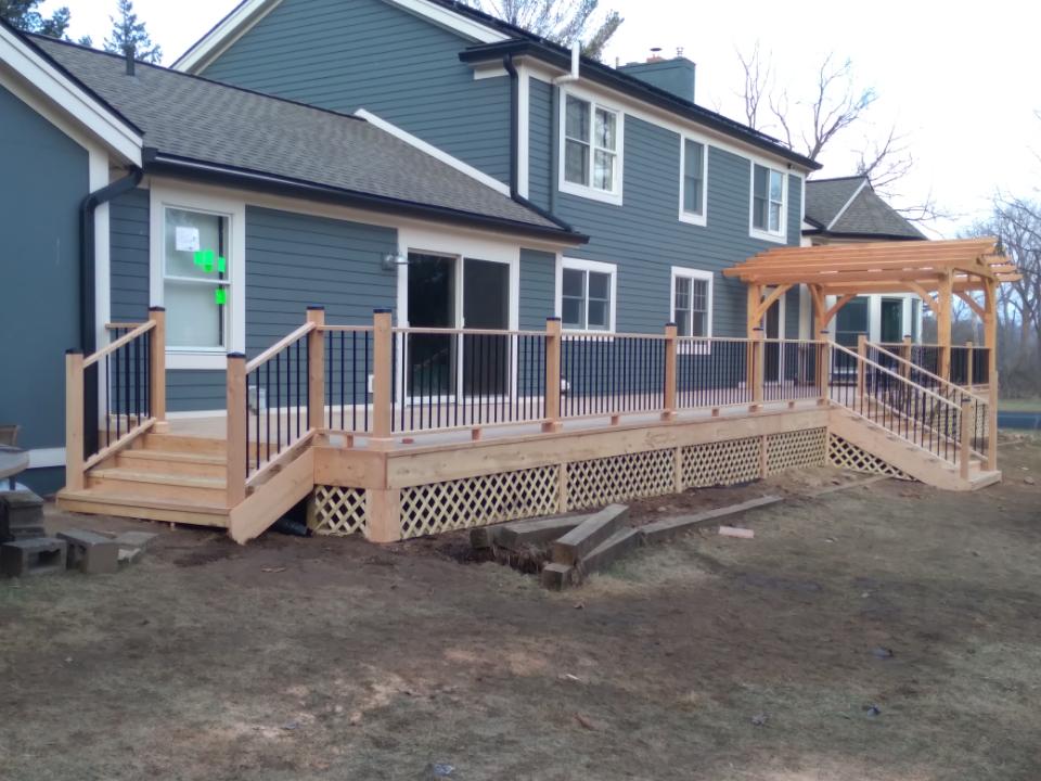 A large Douglas fir wooden deck with a timber frame pavilion.